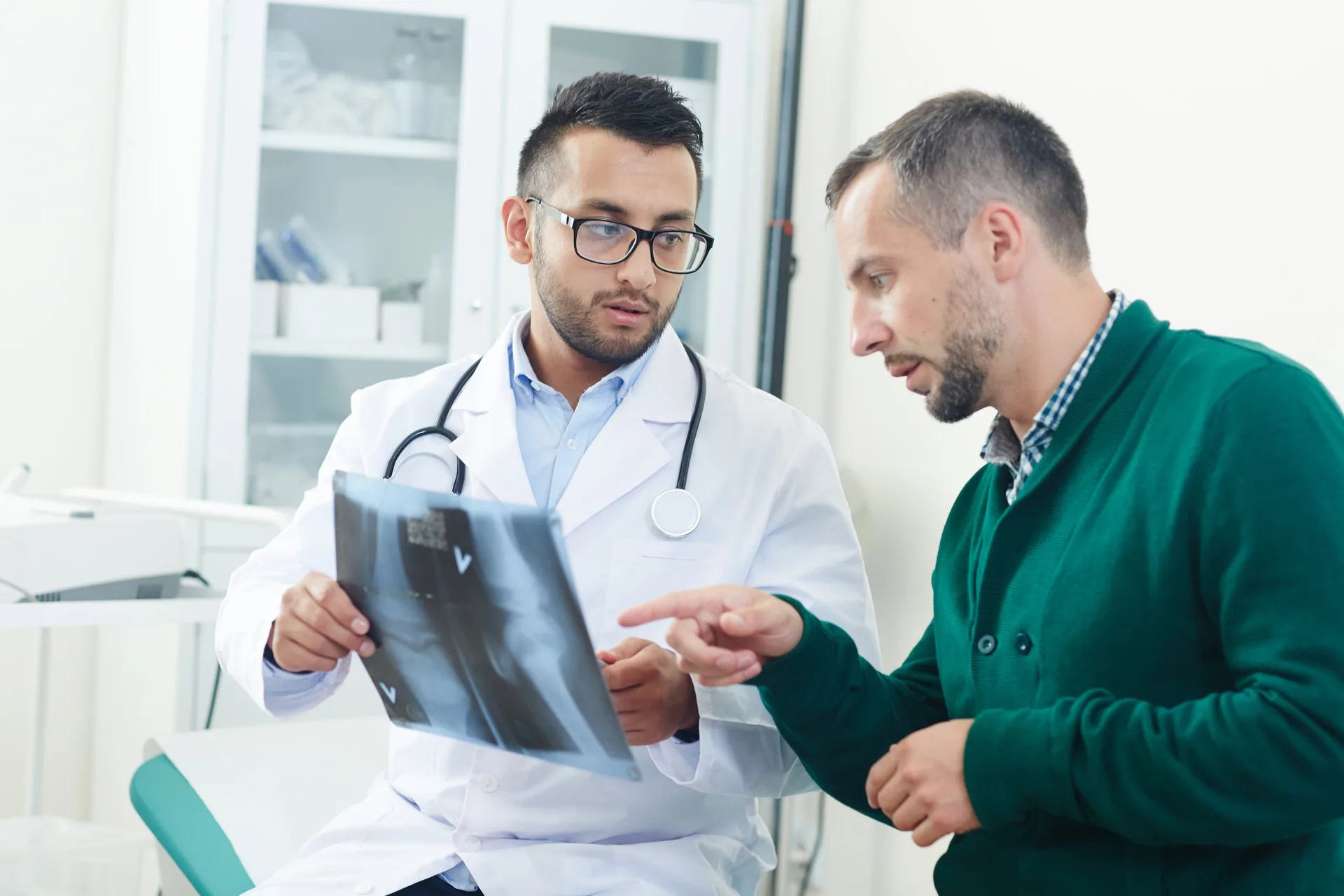 Doctor explaining a joint X-ray to a patient